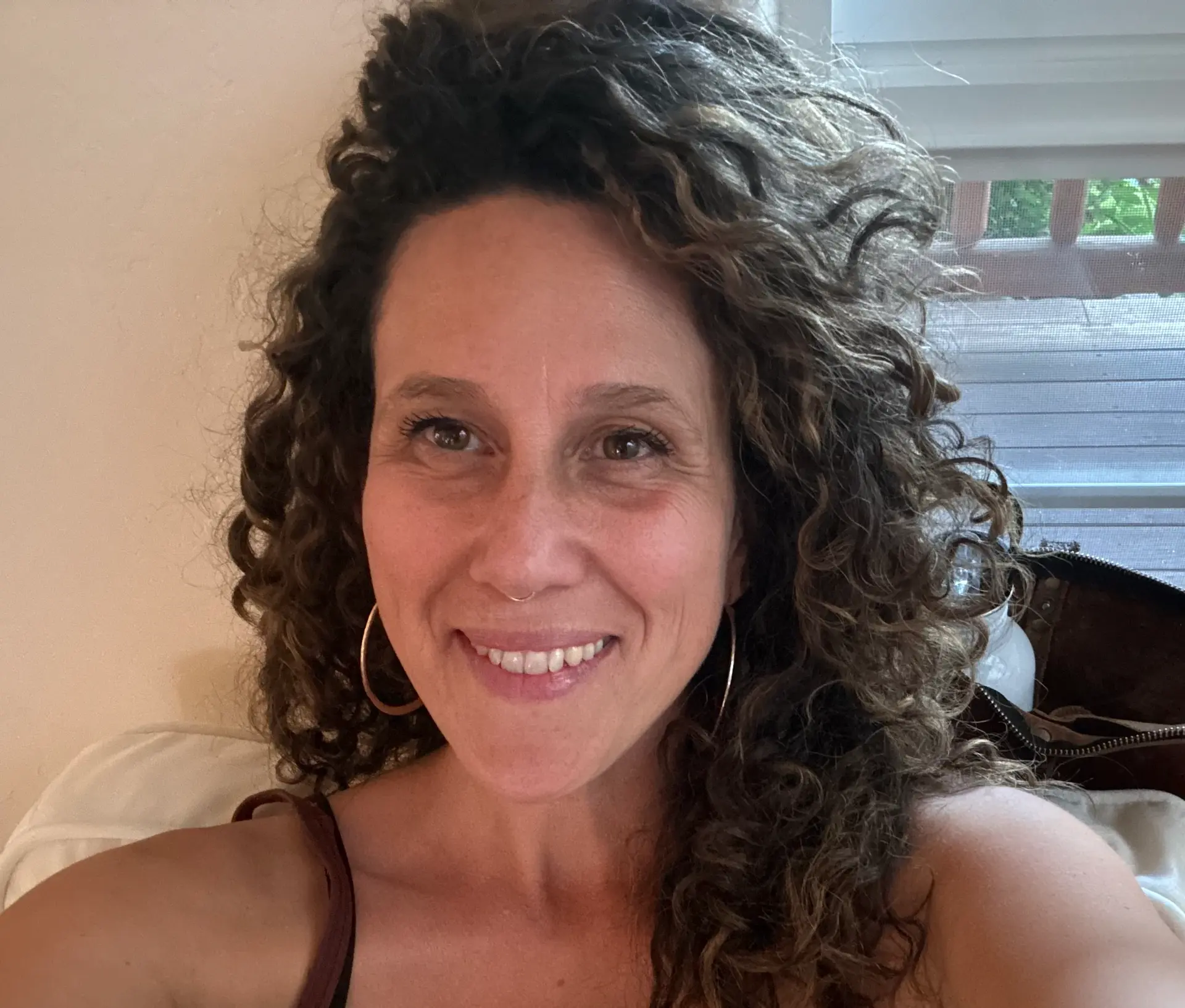 Portrait of Jenny Roberts seated in soft natural light