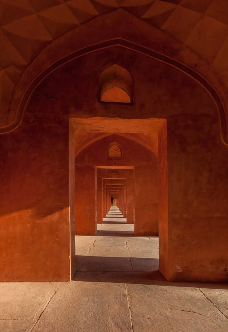 Receding arched doorways in warm red sandstone